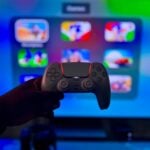 Close-up of a gaming controller against a vibrant screen in London, England.