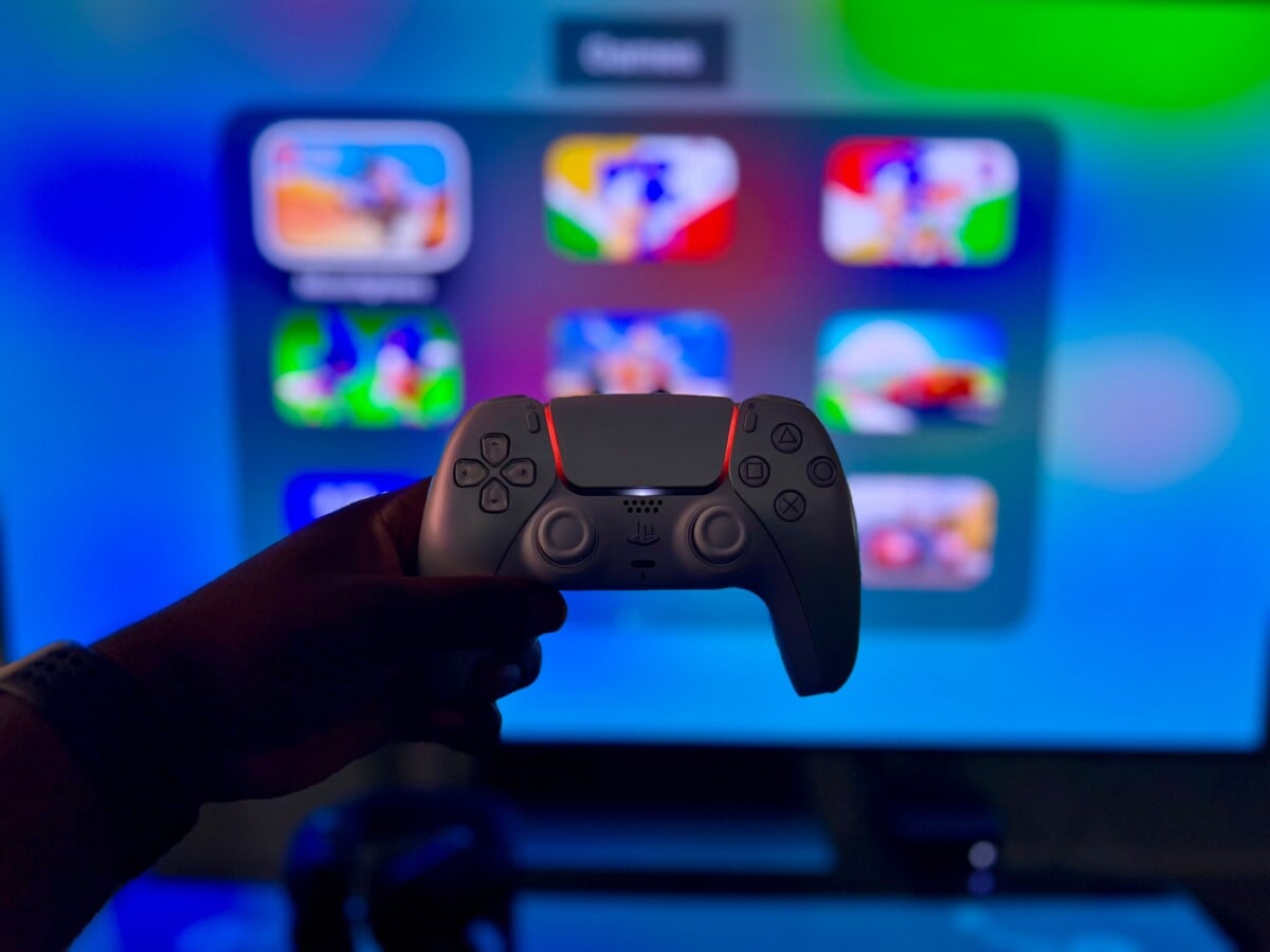 Close-up of a gaming controller against a vibrant screen in London, England.