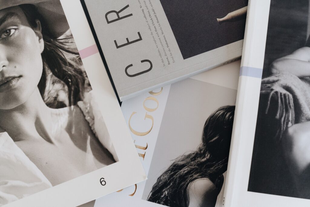 A close-up view of artistic and fashion magazines laid out on a table.